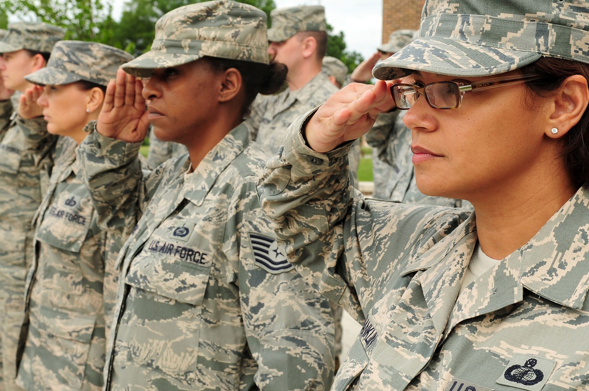 Headquarters Air Force District of Washington Staff Airmen salute during a retreat ceremony, June 6, 2013, at Joint Base Andrews, Md. The ceremony was the second performed by HQ AFDW military personnel to honor the traditions of those who serve and have served for more than sixty years in the Air Force uniform. (U.S. Air Force photo by Senior Airman Steele C. G. Britton)