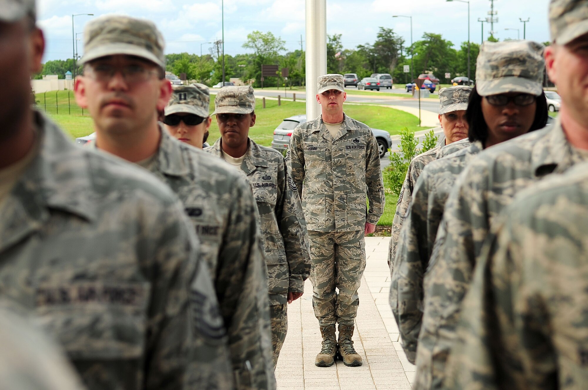 Senior Master Sgt. Johnny Hamm, Air Force District of Washington first sergeant, aligns the formation of Headquarters AFDW Staff Airmen prior to a retreat ceremony, June 6, 2013, at Joint Base Andrews, Md. The ceremony was the second performed by HQ AFDW military personnel to honor the traditions of those who serve and have served for more than sixty years in the Air Force uniform. (U.S. Air Force photo by Senior Airman Steele C. G. Britton) 