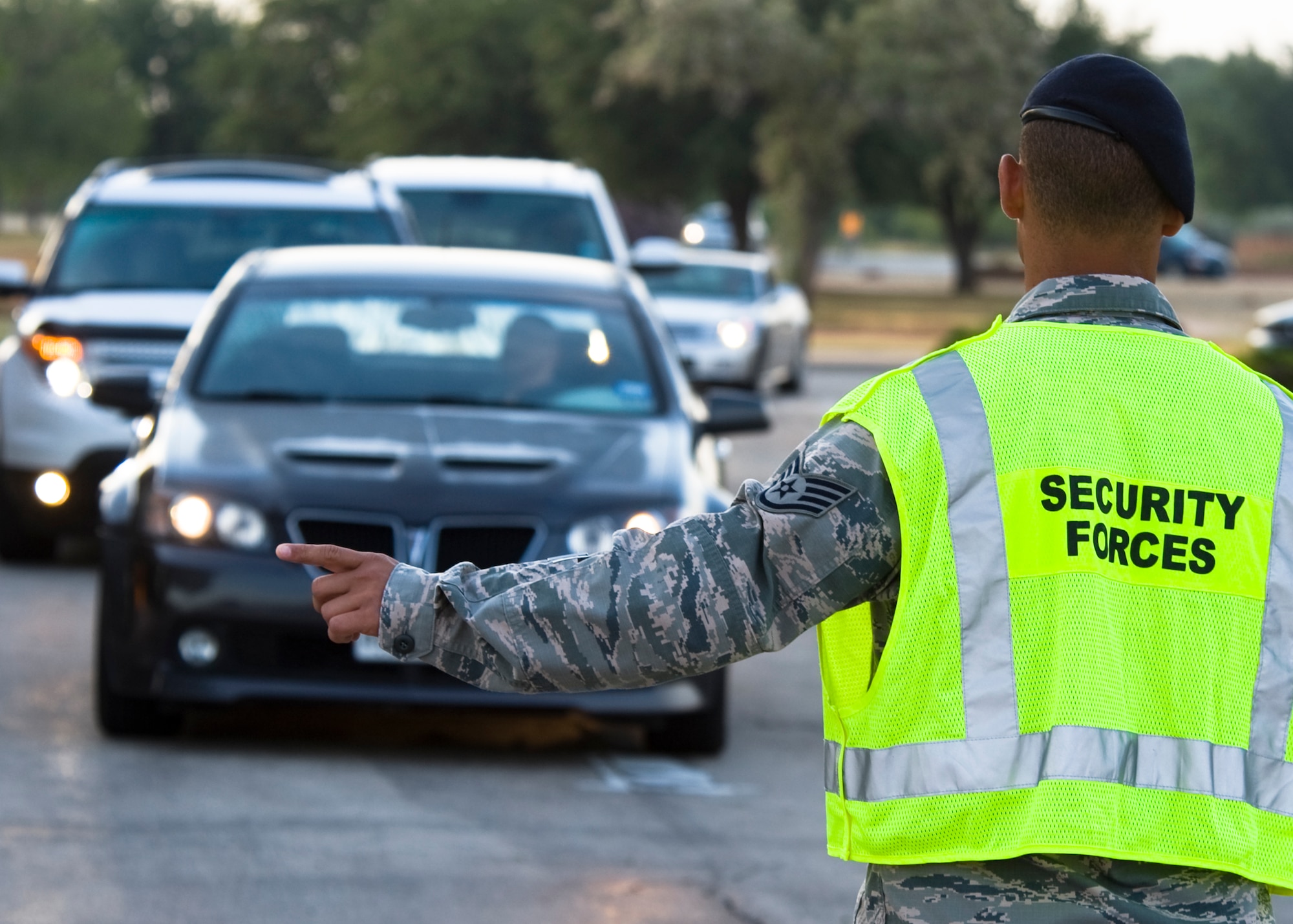 U.S. Air Force Staff Sgt. Andre Hernandez, 7th Security Forces Squadron, directs traffic during a Roadway Blitz June 7, 2013, at Dyess Air Force Base, Texas. 45 off-duty 7th SFS personnel volunteered to participate in the Roadway Blitz with over 112 total man hours dedicated to assuring compliance of state and base vehicle laws. (U.S. Air Force photo by Airman 1st Class Peter Thompson/Released)
