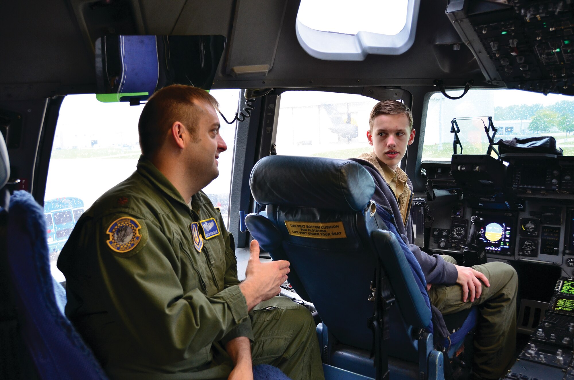 WRIGHT-PATTERSON AIR FORCE BASE, Ohio - Maj. Josh Springman, 89th Airlift Squadron pilot, shows a Boy Scout the flight deck of a C-17 Globemaster III during the 445th Airlift WIng's annual Scouts Day May 18. (U.S. Air Force photo/Staff Sgt. Amanda Duncan)