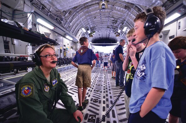 WRIGHT-PATTERSON AIR FORCE BASE, Ohio - Senior Airman Stacey Scharf, 445th Aeromedical Evacuation Squadron technician, demonstrates how to communicate using headsets during the 445th Airlift Wing Scouts Day May 18. (U.S. Air Force photo/Staff Sgt. Mikhail Berlin)