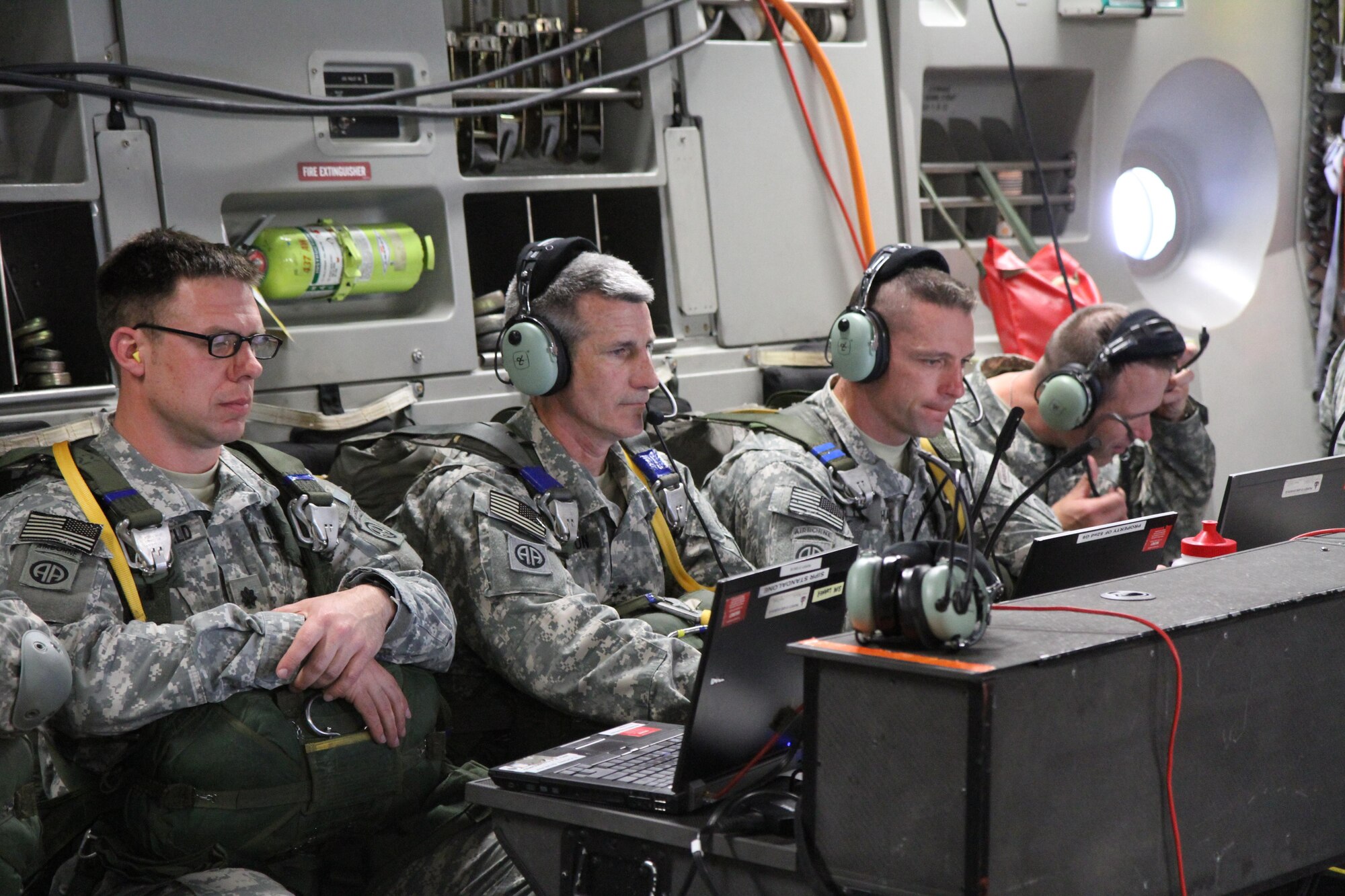 Second from left, Maj. Gen. John W. Nicholson Jr., 82nd Airborne Division commander, receives situational updates on the Fixed Installation Satellite Antenna inside a C17 Globemaster III prior to the airborne insertion during Joint Forces Exercise-Vulnerability. (Photo by: Maj. Loren Bymer)