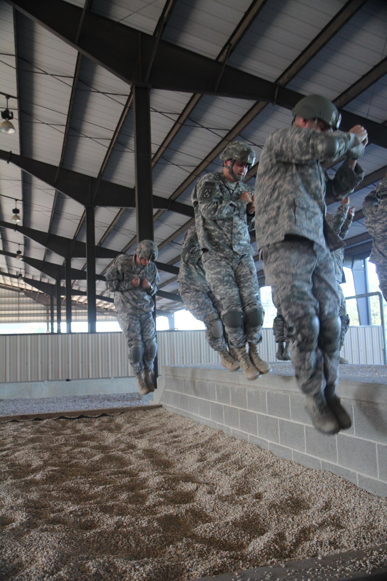 Paratroopers who participated in the Joint Forces Exercise-Vulnerability conduct parachute landing falls as part of pre-jump operations at Pope Army Airfield on May 31, 2013. (Photo by: Sgt. 1st Class Allan Baros)
