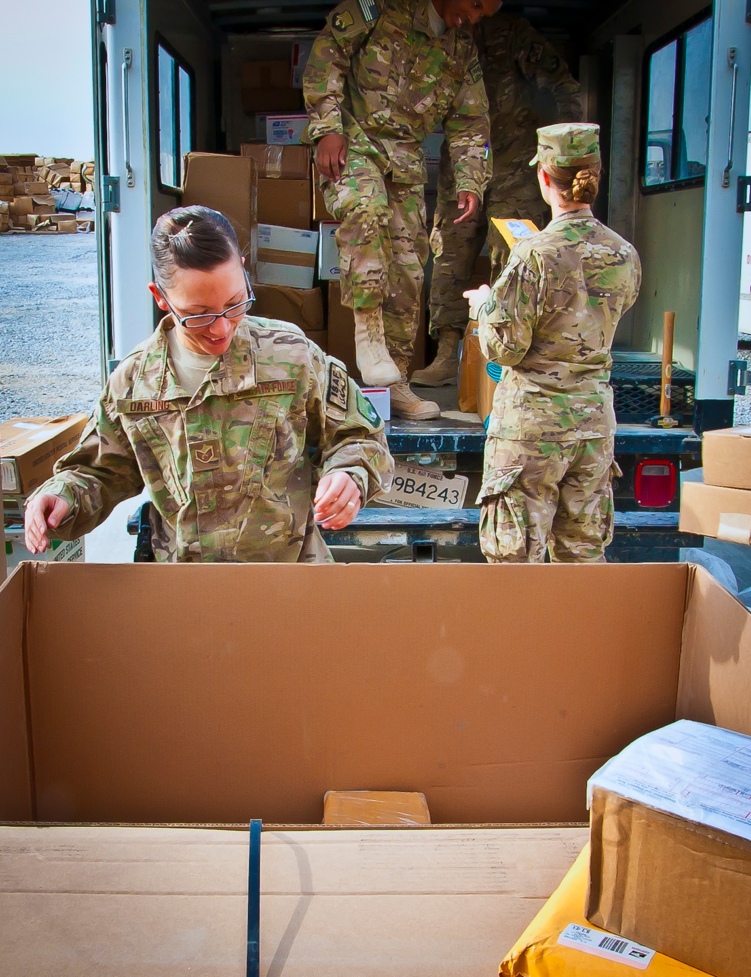 U.S. Air Force Staff Sgt. Hollie Darling, 361st Expeditionary Reconnaissance Squadron and mail crew volunteer, unloads a pallet of mail while determining its final destination at Kandahar Airfield, Afghanistan, May 10, 2013. A team of volunteers across the 451st Air Expeditionary Wing support the wing mail clerk in gathering, sorting and distributing  more than 50,000 pounds of mail a week on average. (U.S. Air Force/photo Senior Airman Scott Saldukas)