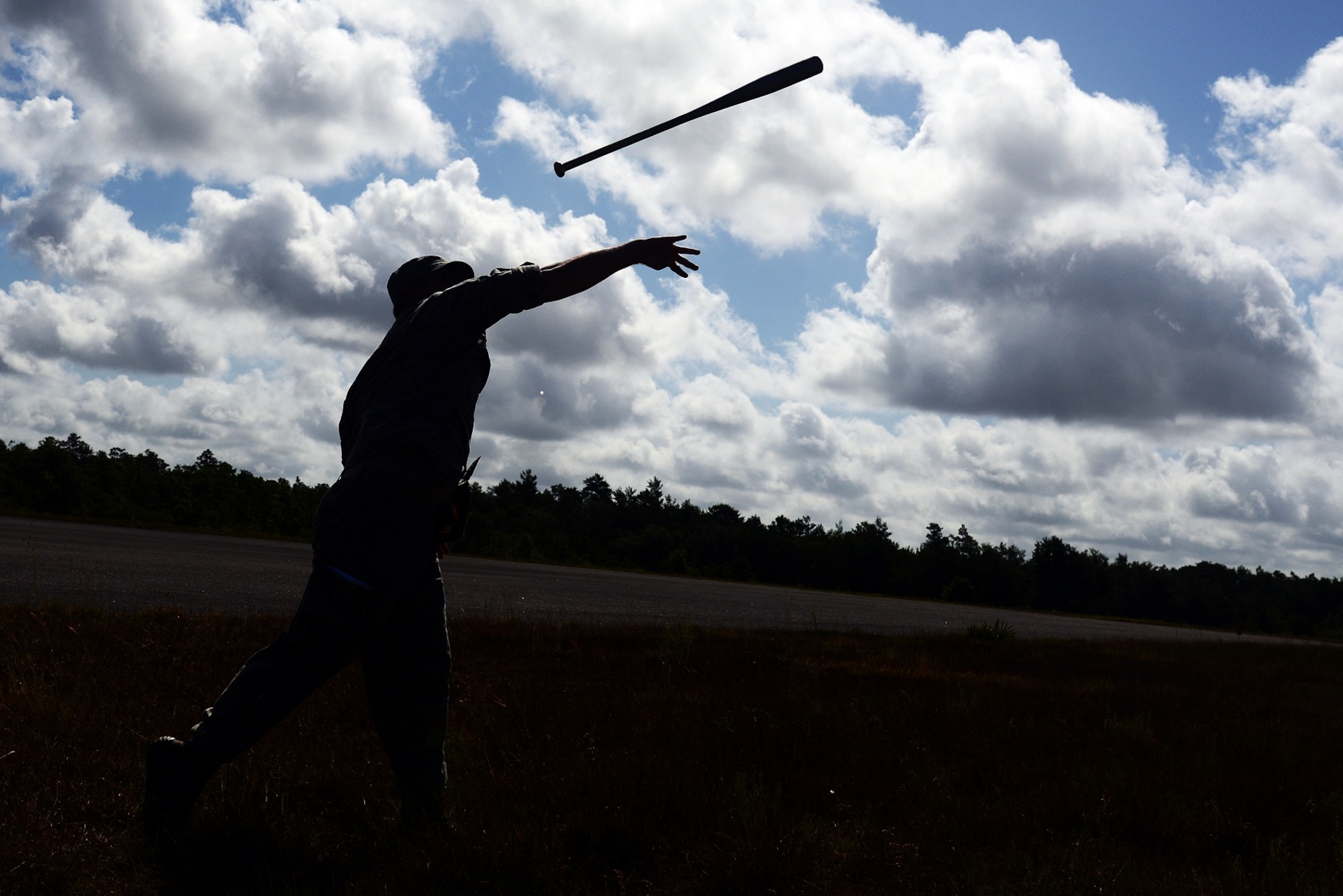 U.S. Air Force Academy Cadet 2nd Class Warren Saunders throws a baseball bat June 5, 2013 during an RQ-11B Raven Small Unmanned Aircraft System initial qualification training course at Choctaw Airfield, Fla. Students practiced throwing a baseball bat several times before they launched a SUAS to avoid unnecessary damages and repairs. The baseball bat is similar in shape and weight to the actual RQ-11B Raven. (U.S. Air Force photo by Staff Sgt. Melanie Holochwost)