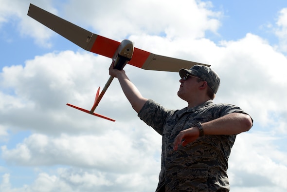 U.S. Air Force Academy Cadet 2nd Class Warren Saunders launches an RQ-11B Raven Small Unmanned Aircraft System during an initial qualification training course June 5, 2013 at Choctaw Airfield, Fla. The Raven is a lightweight, low-altitude SUAS, which can provide real-time imagery directly to the user. (U.S. Air Force photo by Staff Sgt. Melanie Holochwost)