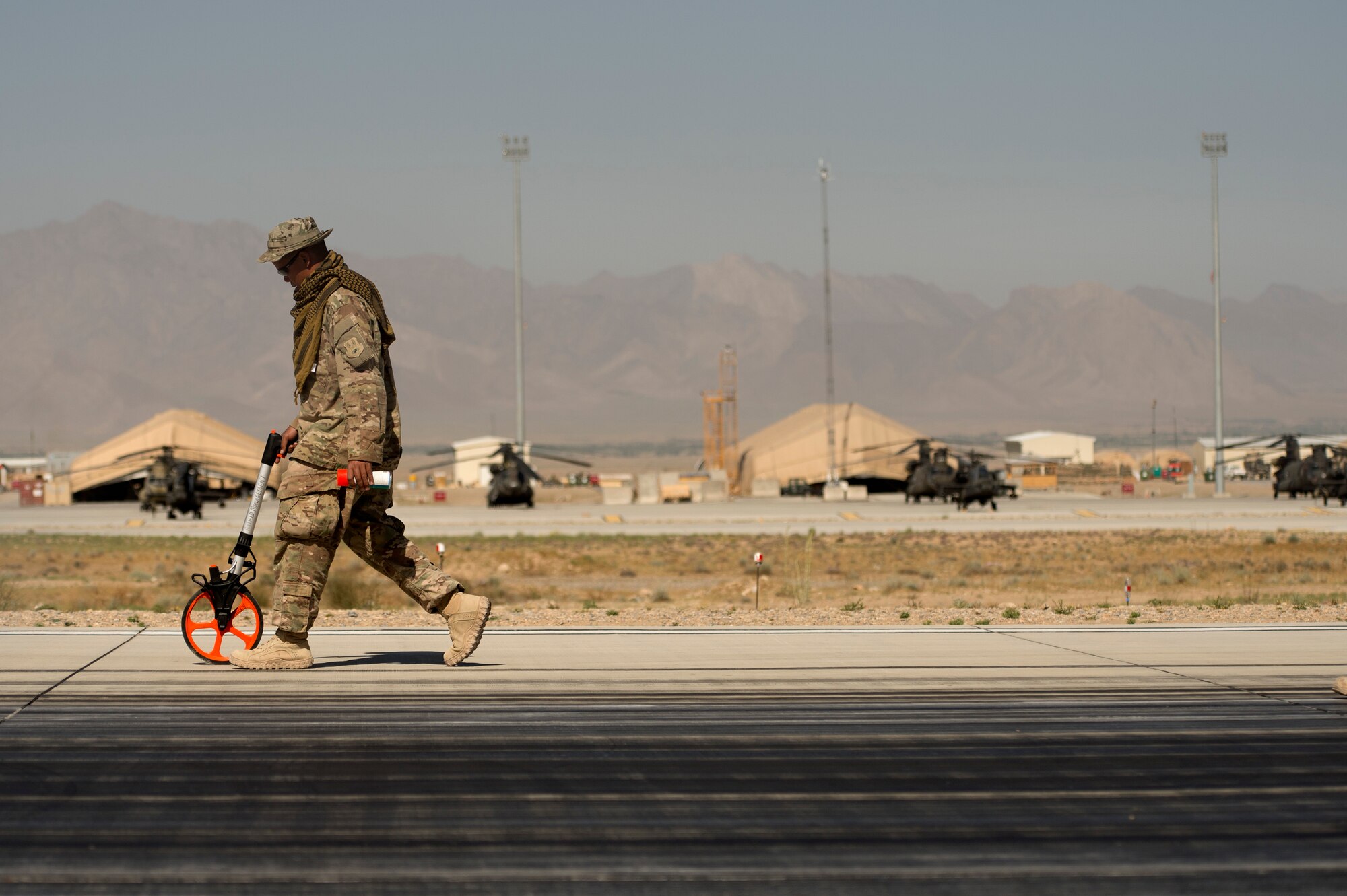 Master Sgt. Arturo Quinones, 577th Expeditionary Prime Base Engineer Emergency Force Squadron, noncommissioned officer in charge of special capabilities, marks off a day's worth of runway requiring rubber removal at Forward Operating Base Shank, Logar province, Afghanistan, June 5, 2013. Runway maintenance is a composite team built from many civil engineering backgrounds. Quinones, hailing from San Antonio, is an electrician by trade. (U.S. Air Force Photo/Master Sgt. Ben Bloker)