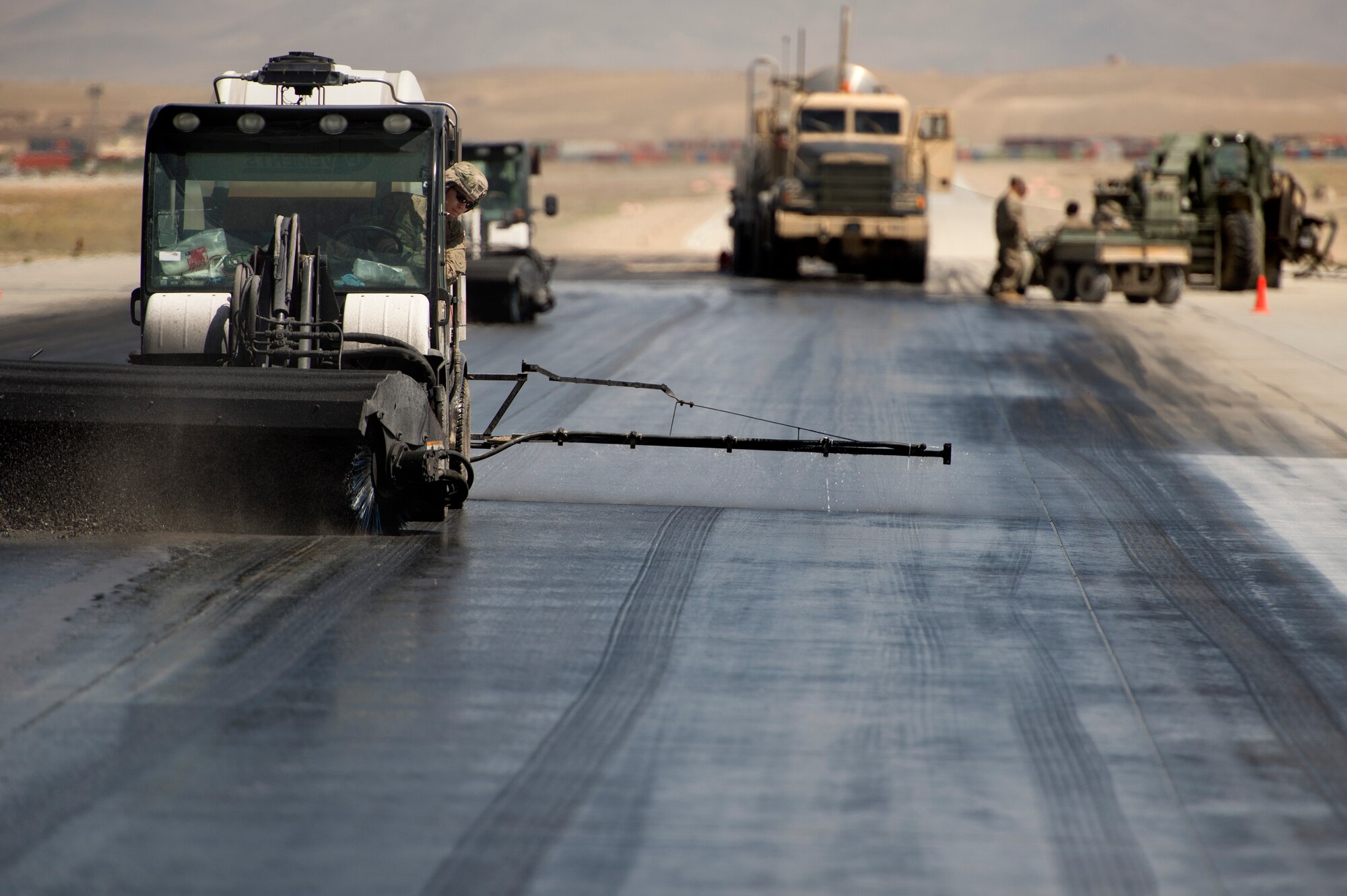Staff Sgt. Trevor Loken, 577th Expeditionary Prime Base Engineer Emergency Force Squadron, monitors rubber removal progress from a Tool Cat on a runway at Forward Operating Base Shank, Logar province, Afghanistan, June 5, 2013. Runway maintenance is a composite team built from many civil engineering backgrounds. Loken, hailing from Ramsey, Minn., is a water utilities maintenance technician by trade. (U.S. Air Force photo/Master Sgt. Ben Bloker)
