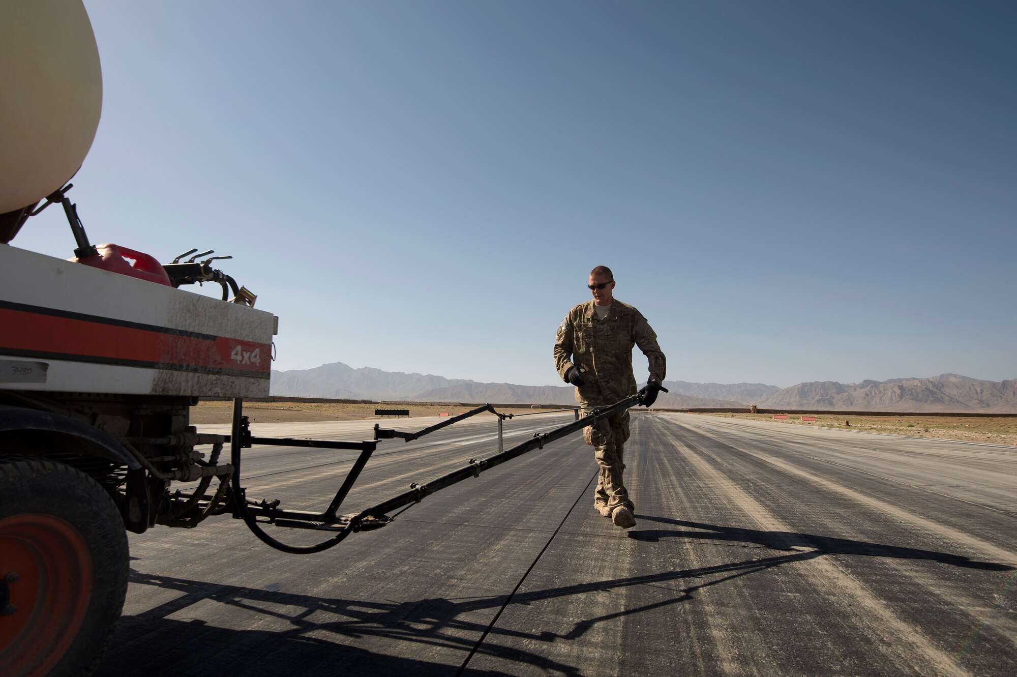 Staff Sgt. Trevor Loken , 577th Expeditionary Prime Base Engineer Emergency Force Squadron, sets up a Tool Cat for rubber removal on a runway at Forward Operating Base Shank, Logar province, Afghanistan, June 5. Loken, hailing from Ramsey, Minn., is a water utilities maintenance technician by trade. (U.S. Air Force photo/Master Sgt. Ben Bloker)