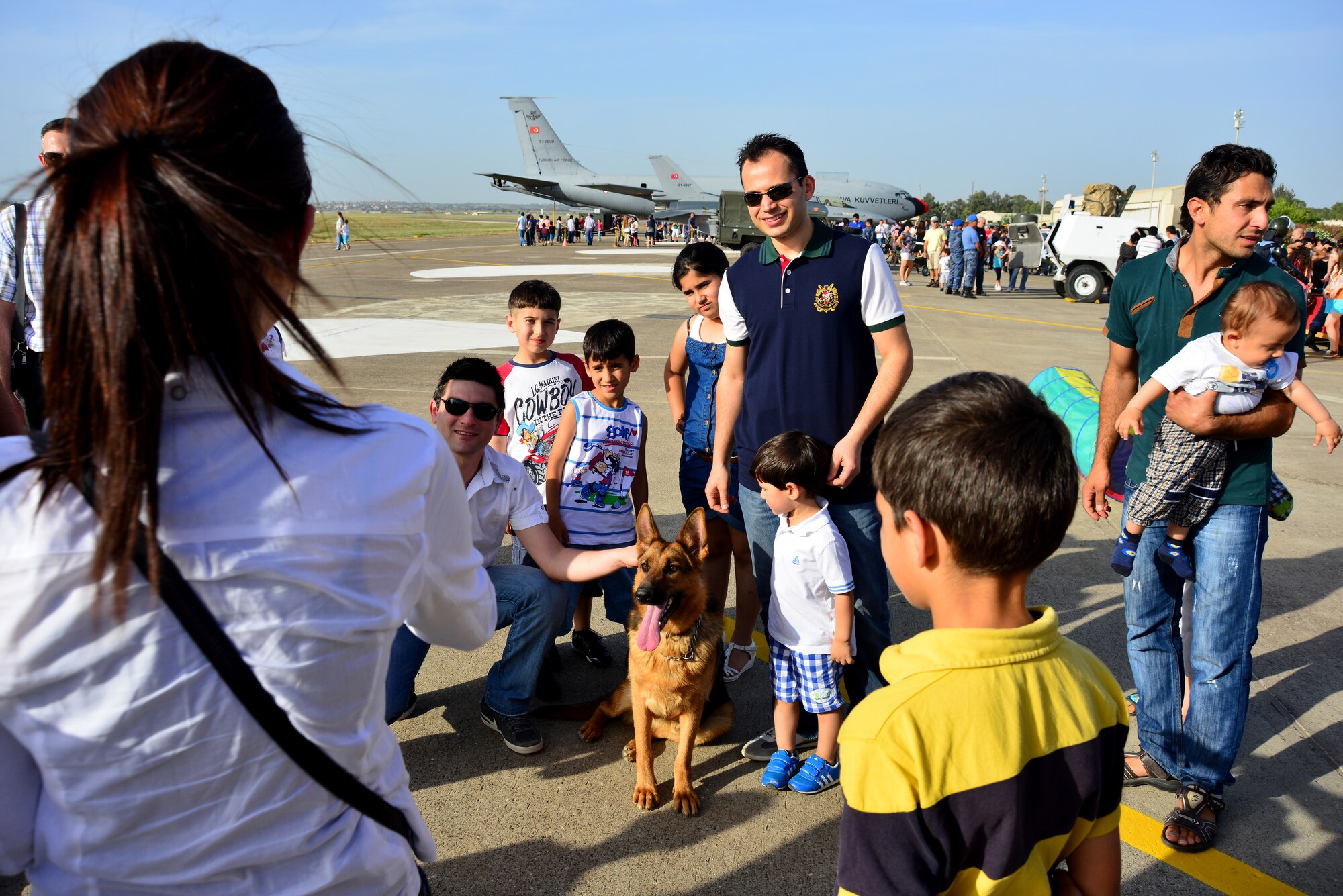 Guests attending the Turkish air force’s 102nd anniversary celebration take photographs with a Turkish military working dog June 9, 2013, at Incirlik Air Base Turkey. The working dogs were one of several displays set up to celebrate the TURAF’s anniversary. (U.S. Air Force photo by Staff Sgt. Eric Summers Jr./Released)