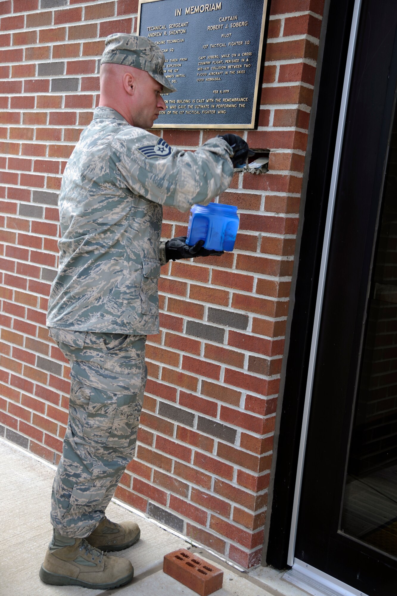 130609-Z-EZ686-022 -- Staff Sgt. Derek Leppek, 127th Civil Engineer Squadron, mortars a the final brick in to place during a building re-dedication ceremony for the 127th Operations Group Building at Selfridge Air National Guard Base, Mich., June 9, 2013. During the ceremony the building, which underwent a $6.6 million overhaul, was re-dedicated to two former members of the 127th, Capt. Robert J. Soderberg and Technical Sgt. Andrew R. Shenton, who were killed in separate incidents while on duty in 1979 and 1981, respectively. (U.S. Air National Guard photo by TSgt. David Kujawa / Released)