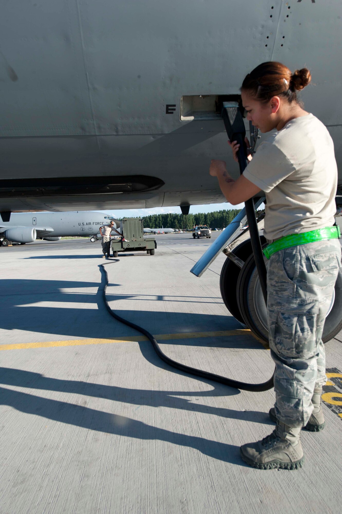 U.S. Air Force Staff Sgt. Kayla Reeh, 376th Expeditionary Aircraft Maintenance Squadron instrument and flight control specialist, plugs a KC-135 Stratotanker into a generator to power it for inspection on the flightline at Transit Center at Manas, Kyrgyzstan, June 7, 2013. Portable generators are used as temporary sources to power an aircraft for maintenance without starting the engines. (U.S. Air Force photo/Staff Sgt. Robert Barnett)