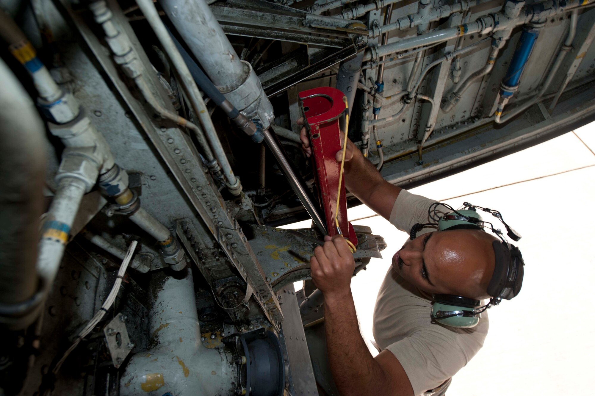 U.S. Air Force Master Sgt. Chris Wieticha, 376th Expeditionary Aircraft Maintenance Squadron hydraulic technician, prepares the door ground safety lock for the KC-135 Stratotanker main landing gear on the flightline at Transit Center at Manas, Kyrgyzstan, June 7, 2013. KC-135s flown out of the Transit Center pump fuel to aircraft on missions in Afghanistan. (U.S. Air Force photo/Staff Sgt. Robert Barnett)