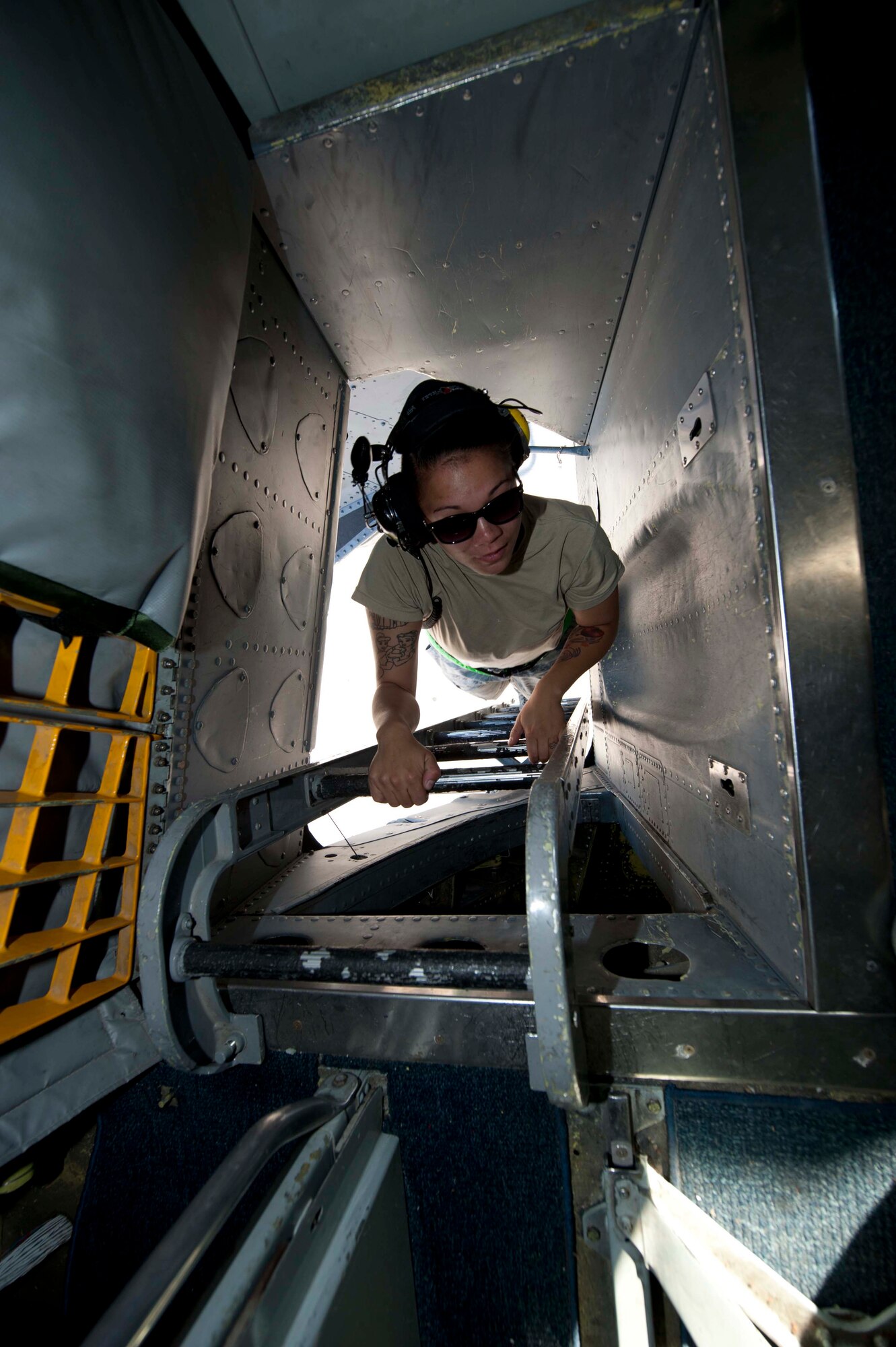 U.S. Air Force Staff Sgt. Kayla Reeh, 376th Expeditionary Aircraft Maintenance Squadron instrument and flight contol specialist, climbs into a KC-135 Stratotanker on the flightline at Transit Center at Manas, Kyrgyzstan, June 7, 2013. Crew members and maintainers hang the ladder in side holes and lower a padded shelf on top of the passageway for safety. (U.S. Air Force photo/Staff Sgt. Robert Barnett)