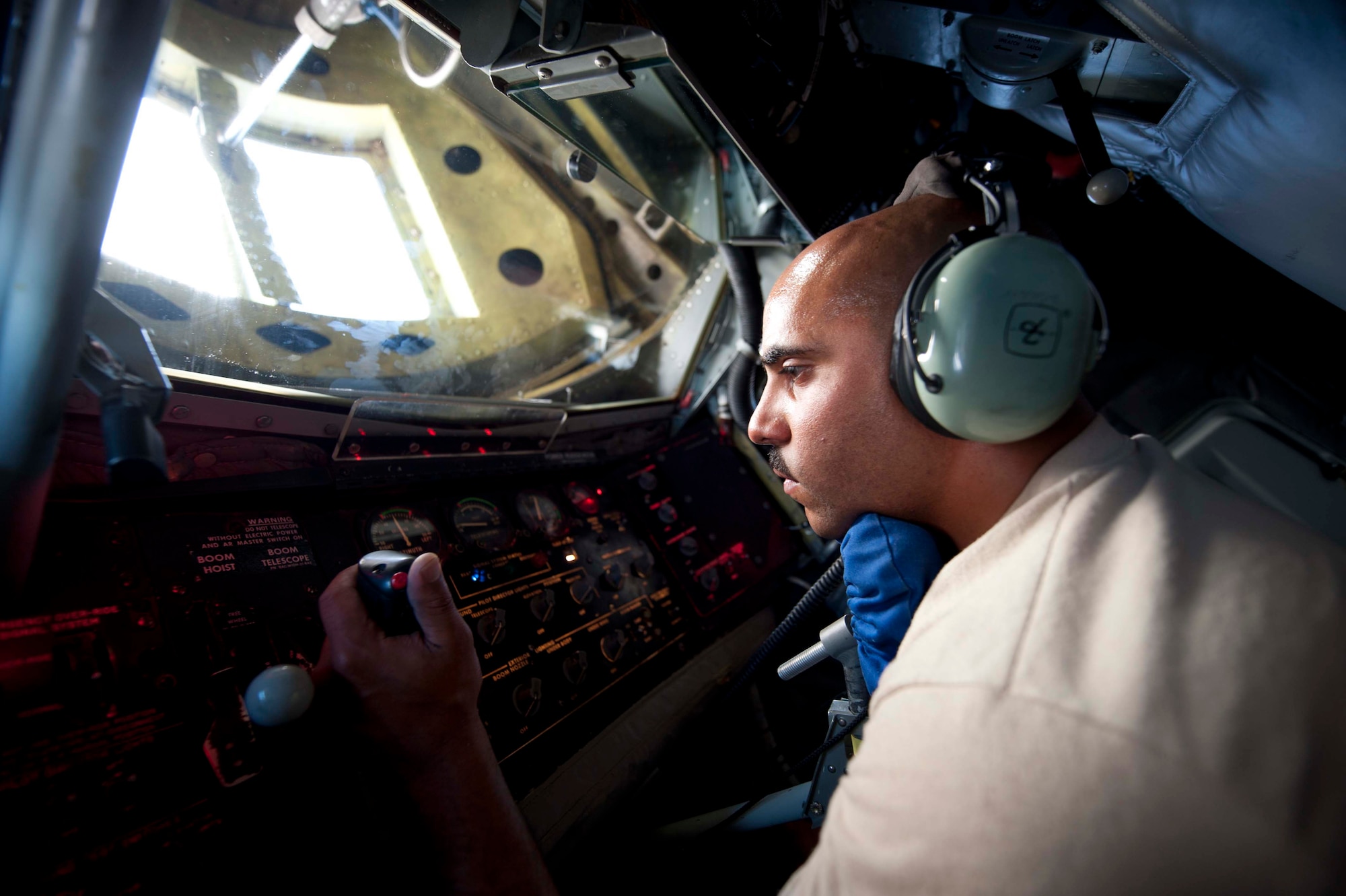 U.S. Air Force Master Sgt. Chris Wieticha, 376th Expeditionary Aircraft Maintenance Squadron hydraulic technician, lies in a boom pad to inspect the raise lever and telescope lever in a KC-135 Stratotanker on the flightline at Transit Center at Manas, Kyrgyzstan, June 7, 2013. The raise lever guides the outer refueling tube, called a boom, and the telescope lever can be used to extend the boom up to 20 feet. (U.S. Air Force photo/Staff Sgt. Robert Barnett)