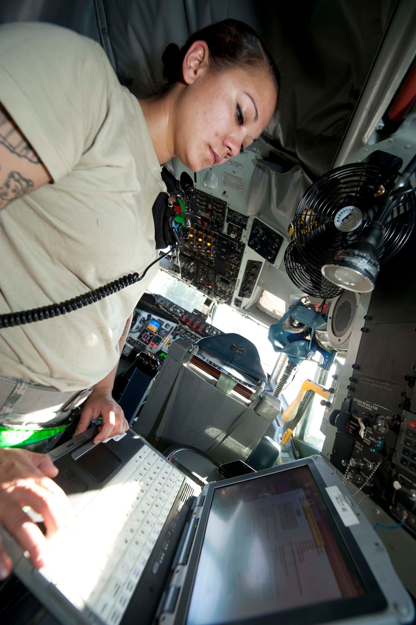 U.S. Air Force Staff Sgt. Kayla Reeh, 376th Expeditionary Aircraft Maintenance Squadron instrument and flight contol specialist, checks technical information in a KC-135 on the flightline at Transit Center at Manas, Kyrgyzstan, June 7, 2013. Reeh also makes regular trips to Afghanistan to continue supporting KC-135s and other aircraft there. (U.S. Air Force photo/Staff Sgt. Robert Barnett)