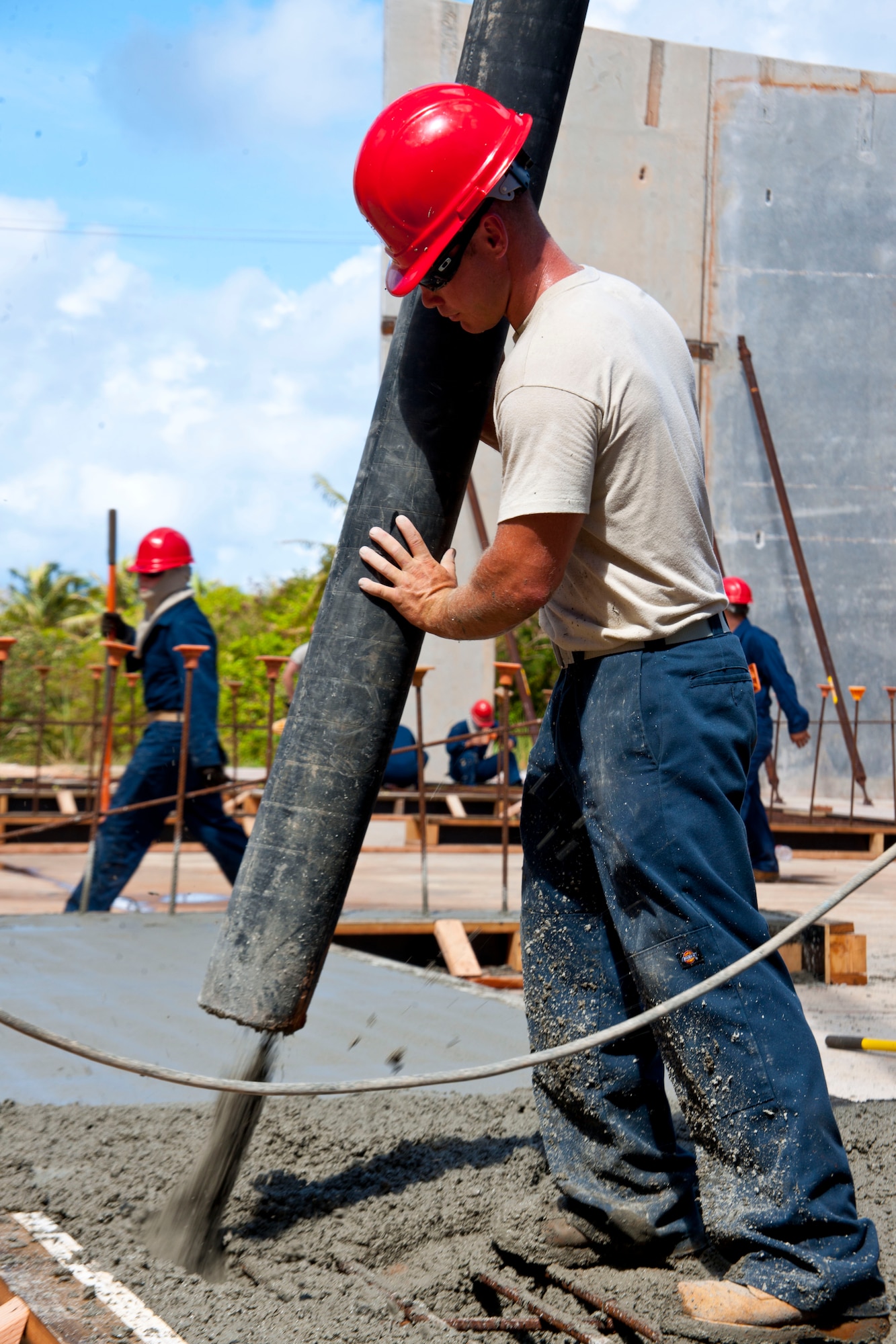 Tech Sgt. David Popp, 554th RED HORSE Squadron engineer, pours concrete for the walls of a tilt-up building May 23, 2013, on Northwest Field, Guam. The 12,500 square foot facility will be used to store all of the electricians’ systems equipment and will be the ninth tilt-up building the engineers have constructed since they began using the method in 2008. (U.S. Air Force photo by Senior Airman Robert Hicks/Released)