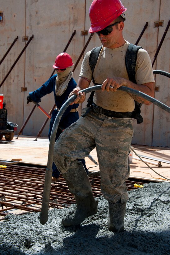 Senior Airman Darren Sharp, 554th RED HORSE Squadron engineer, mixes concrete for the walls of a tilt-up building May 23, 2013, on Northwest Field, Guam. The 12,500 square foot facility will be used to store all of the electricians’ systems equipment and will be the ninth tilt-up building the engineers have constructed since they began using the method in 2008. (U.S. Air Force photo by Senior Airman Robert Hicks/Released) 

