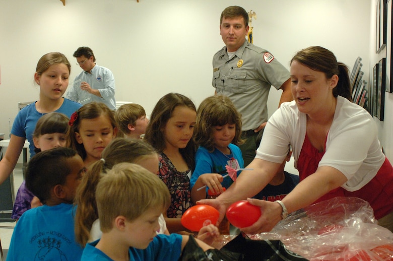 Mary Tipton, a biologist with the U.S. Army Corps of Engineers Nashville District Planning Branch, hands out water safety goodies to kids at the Williamson County Junior Gardener Camp at the Agricultural Exposition Park June 7, 2013. Park Ranger Dean Austin had given the kids a water safety presentation and encouraged them to always wear a life jacket when playing in or around water.