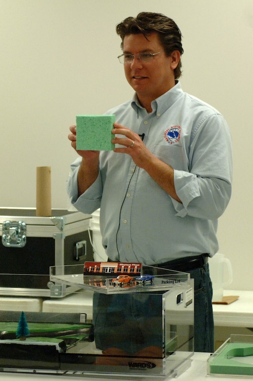 James LaRosa, a service hydrologist with the National Weather Service, demonstrates how rainwater is captured by dams and retention ponds in partnership with the Corps of Engineers at the 2013 Junior Gardener Camp at the Agricultural Exposition Center in Franklin, Tenn., June 7, 2013.