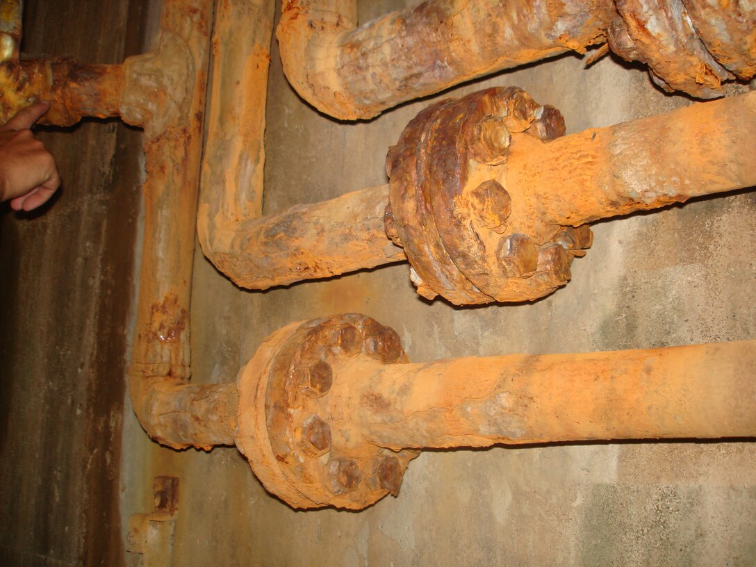 Rusting and corroded galvanized steel hydraulic pipelines used to open and close Miter gates on the McClellan-Kerr Arkansas River Navigation System were installed in the late 60’s or early 70’s.   These pipes are in a very damp environment pumping hydraulic fluids to the gates many times a day, seven days a week.