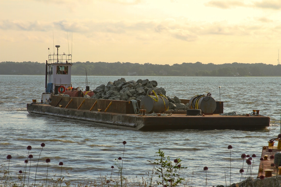 YORKTOWN, Va. – Contractors barge in rock to be used in stabilizing the York River shoreline along 800 feet of the Colonial National Parkway here June 6, 2013. The area is part of more than four miles of shoreline that is in need of stabilization due to severe erosion, which is threatening portions of the parkway and the National Park Service’s Colonial National Historic Park.    (U.S. Army photo/Patrick Bloodgood)  