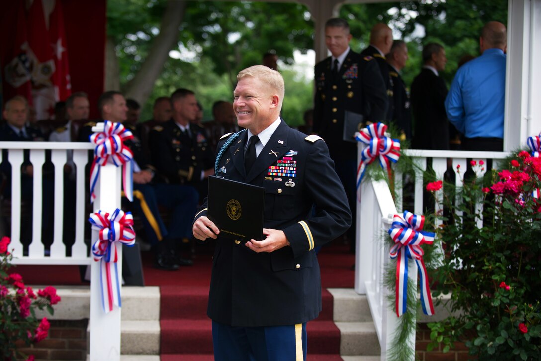 Army Col. Mark O'Donnell smiles after receiving his diploma from the Army War College at the class of 2013 graduation ceremony in Carlisle Barracks, Pa. June 8, 2013.
