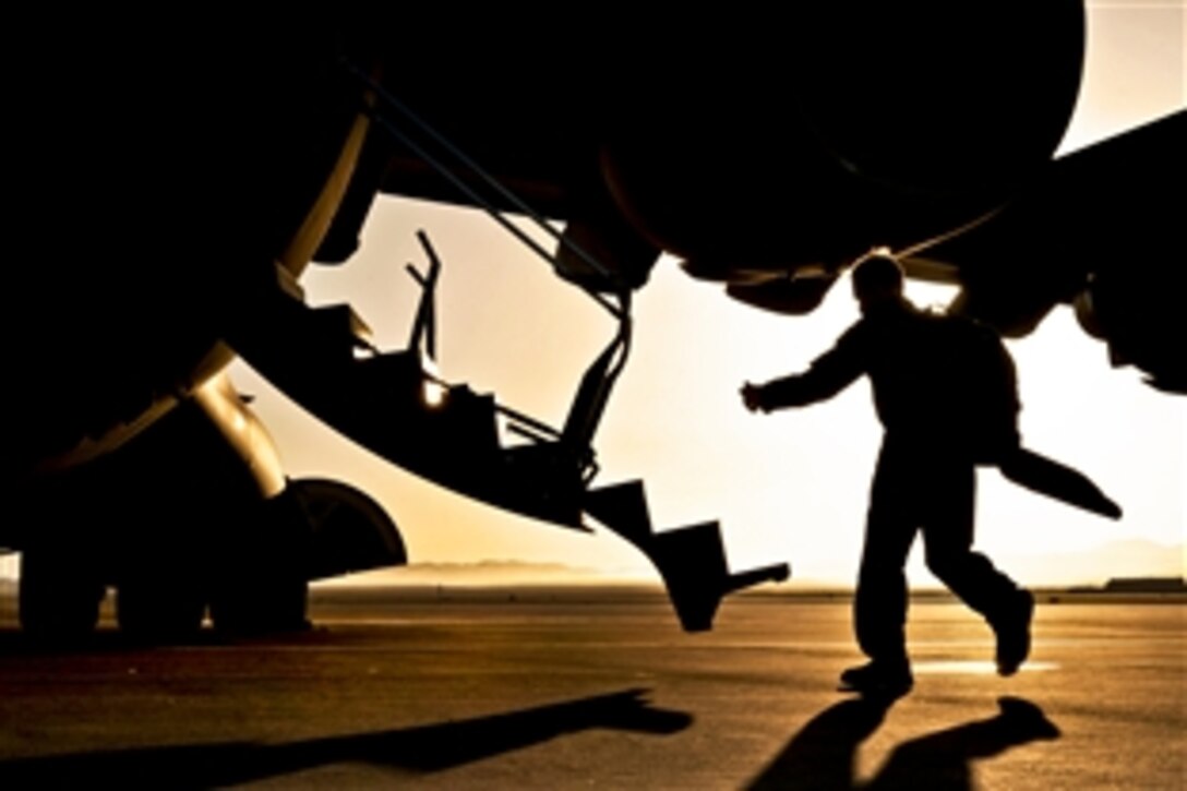 Air Force Maj. Nathan Hangerman boards a C-17 Globemaster aircraft as an instructor during a forcible-entry exercise with airmen and soldiers on Nellis Air Force Base, Nev., May 31, 2013. Hangerman, a pilot, is assigned to the 57th Weapons Squadron. The U.S. Air Force Weapons School sponsors this large-scale, air-mobility exercise in which participants plan and execute a complex air-land operation in a simulated contested battlefield.