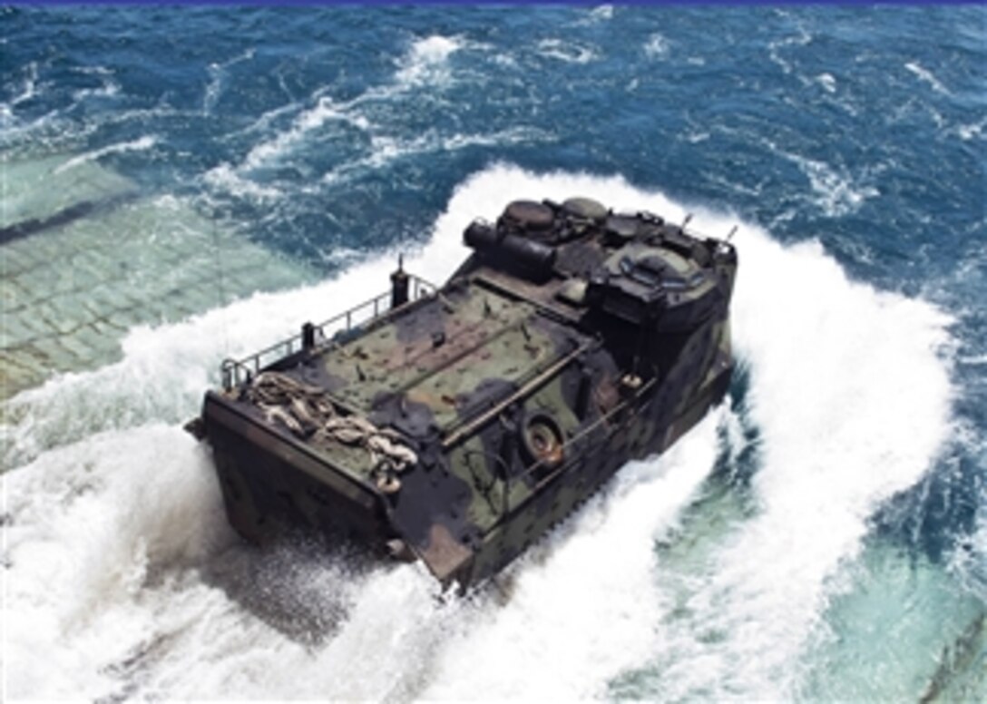 A U.S. Marine Corps amphibious assault vehicle plunges into the Gulf of Thailand as it exits the well deck of the amphibious dock landing ship USS Tortuga (LSD 46) in preparation for a joint amphibious assault exercise with the Royal Thai navy during the Cooperation Afloat Readiness and Training, or CARAT, on June 9, 2013.  CARAT is a series of bilateral military exercises between the U.S. Navy and the armed forces of Bangladesh, Brunei, Cambodia, Indonesia, Malaysia, the Philippines, Singapore, Thailand and Timor Leste.  