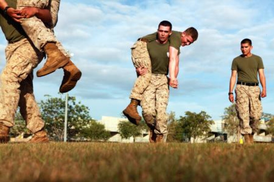 A Marine with Lima Company, 3rd Battalion, 3rd Marine Regiment, Marine Rotational Force – Darwin, completes a fireman’s carry during a combat conditioning portion of a Marine Corps Martial Arts Program class, here, June 6. The company’s goal is to upgrade every Marine to green belt by the end of the rotation.
