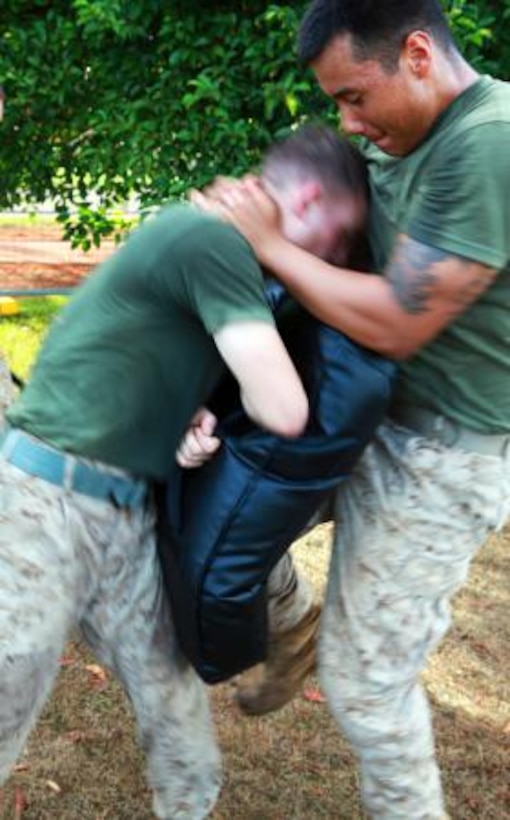 A Marine with Lima Company, 3rd Battalion, 3rd Marine Regiment, Marine Rotational Force – Darwin, completes a vertical knee strike during a Marine Corps Martial Arts Program class, here, June 6. The company’s goal is to upgrade every Marine to green belt by the end of the rotation.
