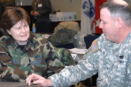 Brig. Gen. Frances Auclair, Maine National Guard chief of staff, and Col. Mark Lovejoy, Vermont National Guard director of Force Structure, Resources and Assessment, discuss a briefing at the Joint Task Force Commander Training Course Jan. 29, 2008, at U.S. Nothern Command headquarters at Peterson Air Force Base, Colo. USNORTHCOM conducts the four-day course twice each year for Army and Air National Guard senior officers who have been nominated by their state adjutants general as potential joint task force commanders. The course presents attendees with a compilation of current policy, directives, guidance and lessons learned regarding the command of a joint task force in the United States and prepares the officers to effectively operate in situations requiring the mobilization of National Guard and active-duty forces. 