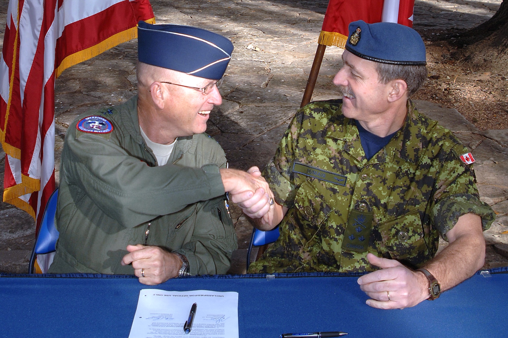 U.S. Air Force Gen. Gene Renuart, left, commander of North American Aerospace Defense Command and U.S. Northern Command, and Canadian Air Force Lt.-Gen. Marc Dumais, commander of Canada Command, signed a Civil Assistance Plan that allows the military from one nation to support the armed forces of the other nation during a civil emergency. The signing took place at U.S. Army North headquarters, Fort Sam Houston, Texas, Feb. 14, 2008. 