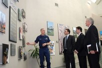 Department of Homeland Security officials stop at the 9-11 tribute wall during a visit to the headquarters of North American Aerospace Defense Command and U.S. Northern Command on Feb. 25, 2008. From left to right are Coast Guard Rear Adm. Dan Lloyd, DHS military advisor; Brian White, DHS chief of staff to deputy secretary; Chad Sweet, DHS chief of staff; and Fred Schwien, DHS executive secretary/executive director for operations and administration. The group came to the commands to meet key staff members and discuss mutual civil support and homeland defense issues.