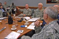 Lt. Gen. H Steven Blum, left, chief of the National Guard Bureau, and Lt. Gen. William Webster, center, deputy commander of U.S. Northern Command, discuss the 2007 military response to Hurricane Dean during USNORTHCOM's Hurricane Preparation Conference at Peterson Air Force Base, Colo., on March 14, 2008. Adjutants general from hurricane-prone states and territories participated in the third annual conference, along with representatives from the Department of Homeland Security, FEMA, Navy, Coast Guard, Army, Air Force and Canada Command. 