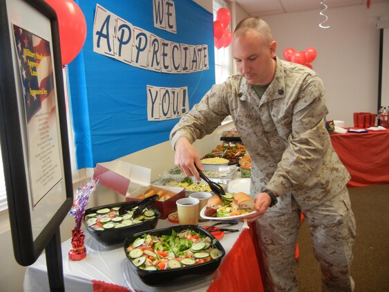 Staff Sgt. Daniel Green, cyber security technician at Marine Corps Operations and Security Command piles food onto his plate during the Voluntary Education Center’s student appreciation luncheon April 23, 2013, aboard Marine Corps Base Quantico. Green is studying computer information systems at DeVry University. 