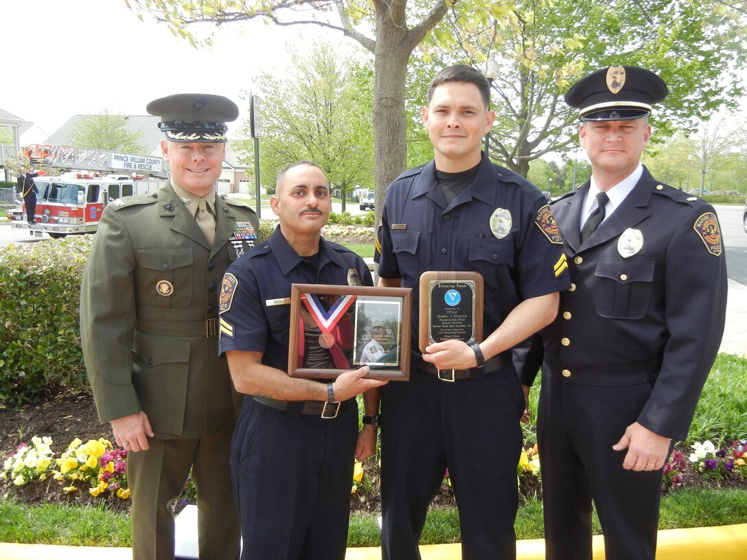Col. Barry Neulen, commanding officer of Security Battalion aboard Marine Corps Base Quantico stands with Michael Rivera and Bradley Montoya, civilian police officers with the Provost Marshall Office, at the Prince William County Valor Awards on April 24, 2013, in Gainesville.  Rivera was presented the Bronze Medal for saving a crash victim from a burning vehicle last May. Montoya was presented the Lifesaving Award for resuscitating a man found unconscious along a running trail last February. 