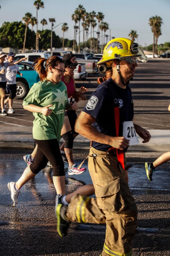 City of Yuma firefighters came out in full firefighting gear to support the 3rd Annual Fire Hose 5k Fun Run aboard Marine Corps Air Station Yuma, Ariz., June 8.  The on-base military and civilian firefighting units supported the run with the assistance of their military personnel, fire trucks and fire hoses.  