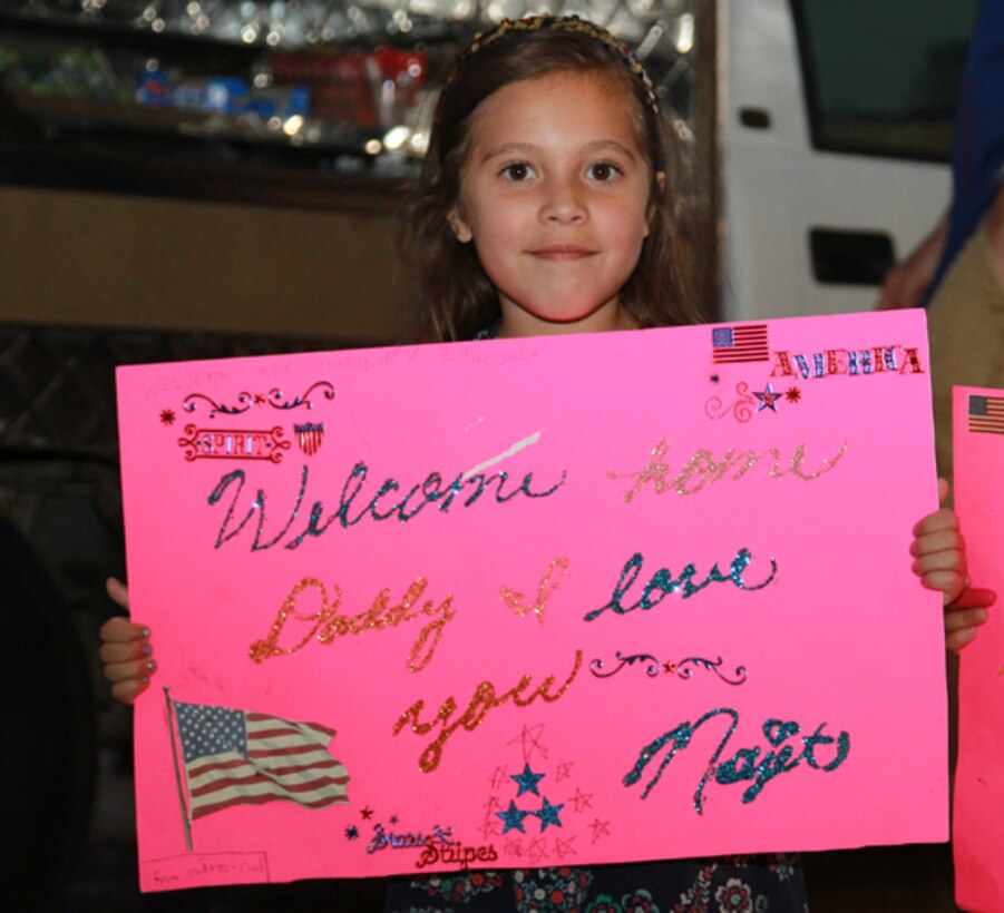 Najet Martinez, 6, holds up a sign for her father, Staff Sgt. Calixtro Martinez, during Marine Unmanned Aerial Squadron 3â€™s homecoming, May 19. 