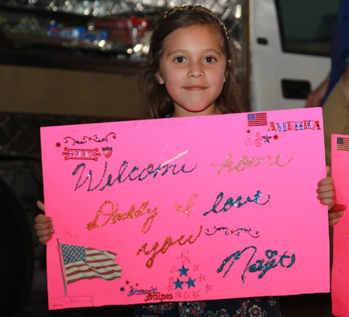 Najet Martinez, 6, holds up a sign for her father, Staff Sgt. Calixtro Martinez, during Marine Unmanned Aerial Squadron 3â€™s homecoming, May 19. 