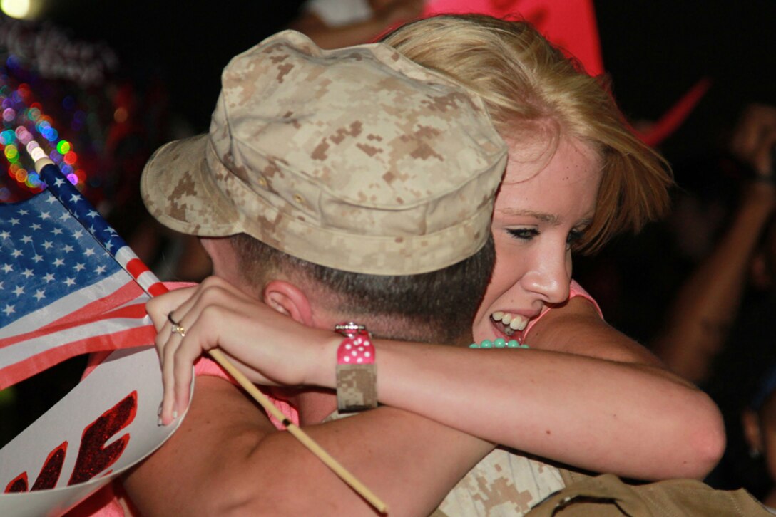 Cpl. Wealey Purdue, motor transportation mechanic, Marine Unmanned Aerial Vehicle Squadron 3, hugs his wife,
Hayleigh, during his unit’s homecoming May 19.