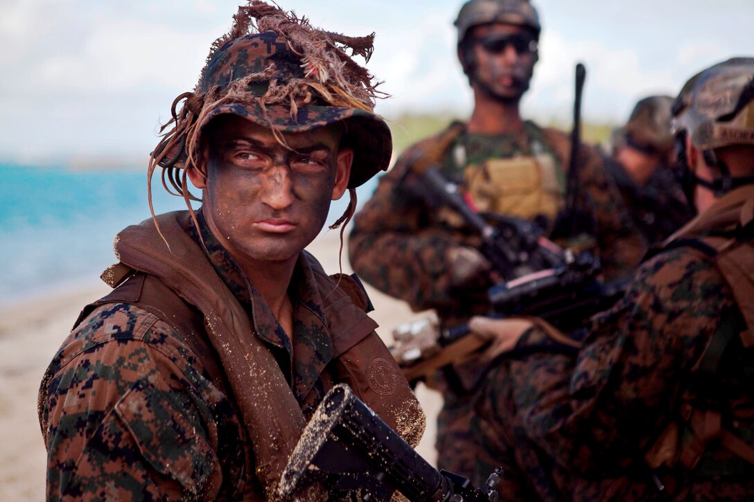 Lance Cpl. Eric A. Sundquist, a scout swimmer with Company F., Battalion Landing Team 2nd Battalion, 4th Marines, 31st Marine Expeditionary Unit, provides security during an accountability halt of a notional boat raid here, June 8. The training exercise allowed the force to practice every aspect of an amphibious raid, except for the use of a Navy ship as the starting point, before their upcoming deployment. The 31st MEU is the Marine Corps’ force in readiness for the Asia-Pacific region and is the only continuously forward-deployed MEU.
