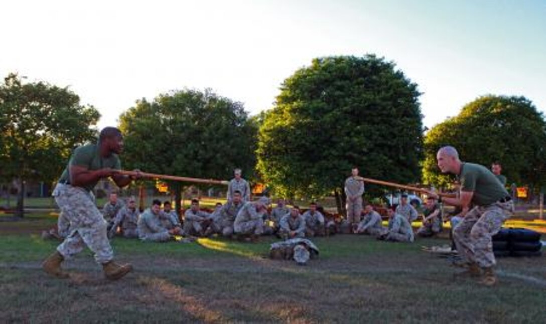Gunnery Sgt. Marcus Gold (left), company gunnery sergeant and martial arts instructor trainer, Lima Company, 3rd Battalion, 3rd Marine Regiment, Marine Rotational Force – Darwin, and Sgt. Matthew Barker, machine gun section leader and martial arts instructor trainer, Weapons Platoon, Lima Co., 3rd Bn., 3rd Marine Regiment, MRF-D, teach Marine Corps Martial Arts Program techniques during a class, here, June 3. The company’s goal is to upgrade every Marine to green belt by the end of the rotation.

