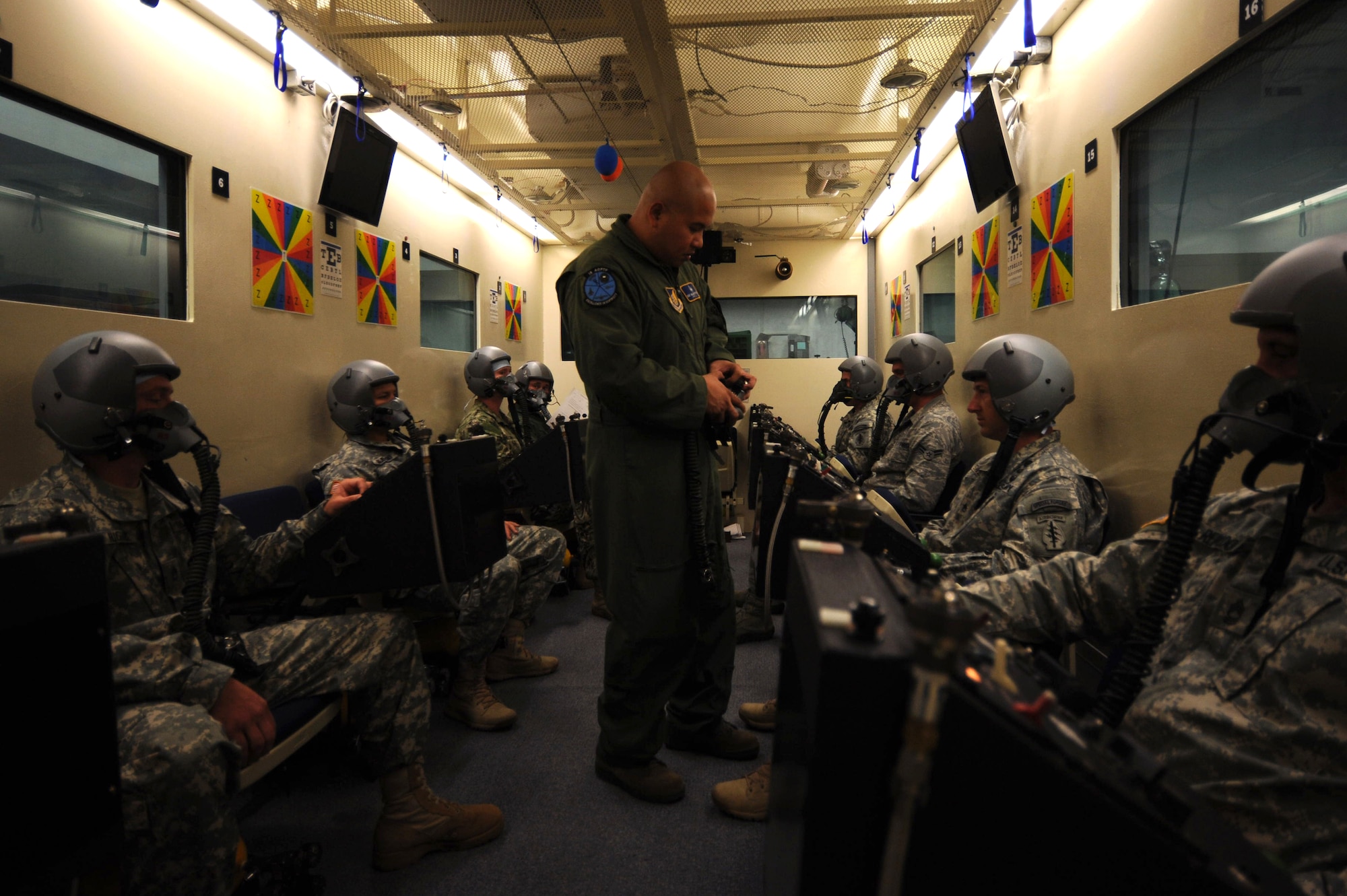 U.S. Air Force Staff Sgt. Nazareth Oliver, 18th Aerospace Medicine Squadron aerospace and operational physiology flight NCO in charge of maintenance, inspects a face mask in the altitude chamber on Kadena Air Base, Japan, June 11, 2013. The altitude chamber is designed to familiarize service members who fly in aircraft at high altitudes of the symptoms related to a lack of oxygen, and trains them on how to correct and recover from those symptoms. (U.S. Air Force photo by Airman 1st Class Hailey R. Davis/Released)