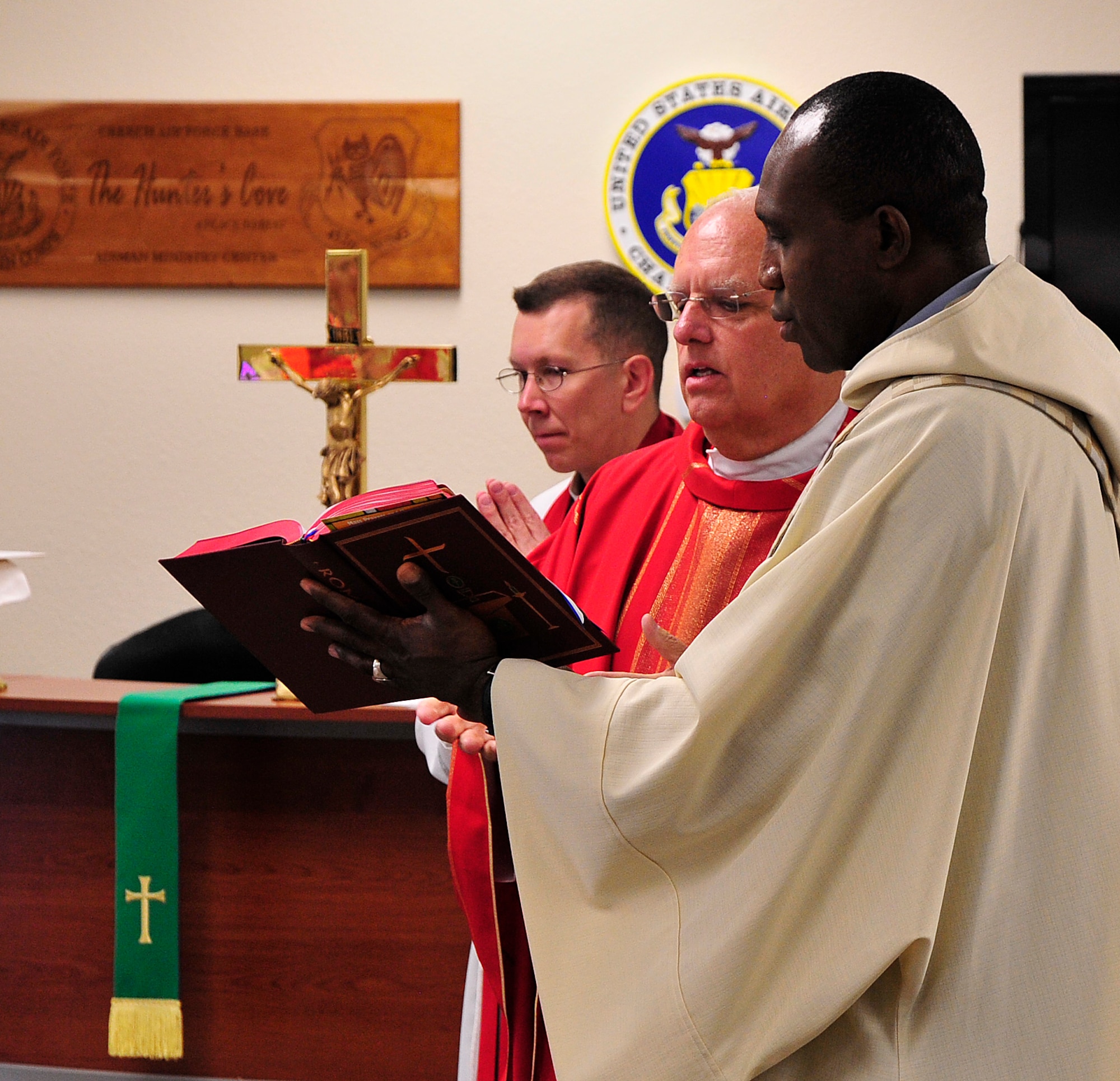 LAS VEGAS, Nev. -- From left, Fathers Brian Wood, John Kinney, and Joseph Idomele celebrate Mass as part of the U.S. Air Force’s “Come Be With Us” chaplain recruiting tour June 11, 2013.  The tour brings active duty chaplains and civilian priests to Nellis and Creech Air Force Base to help recruit new chaplains. (U.S. Air Force photo by Staff Sgt. D.H./Released))
