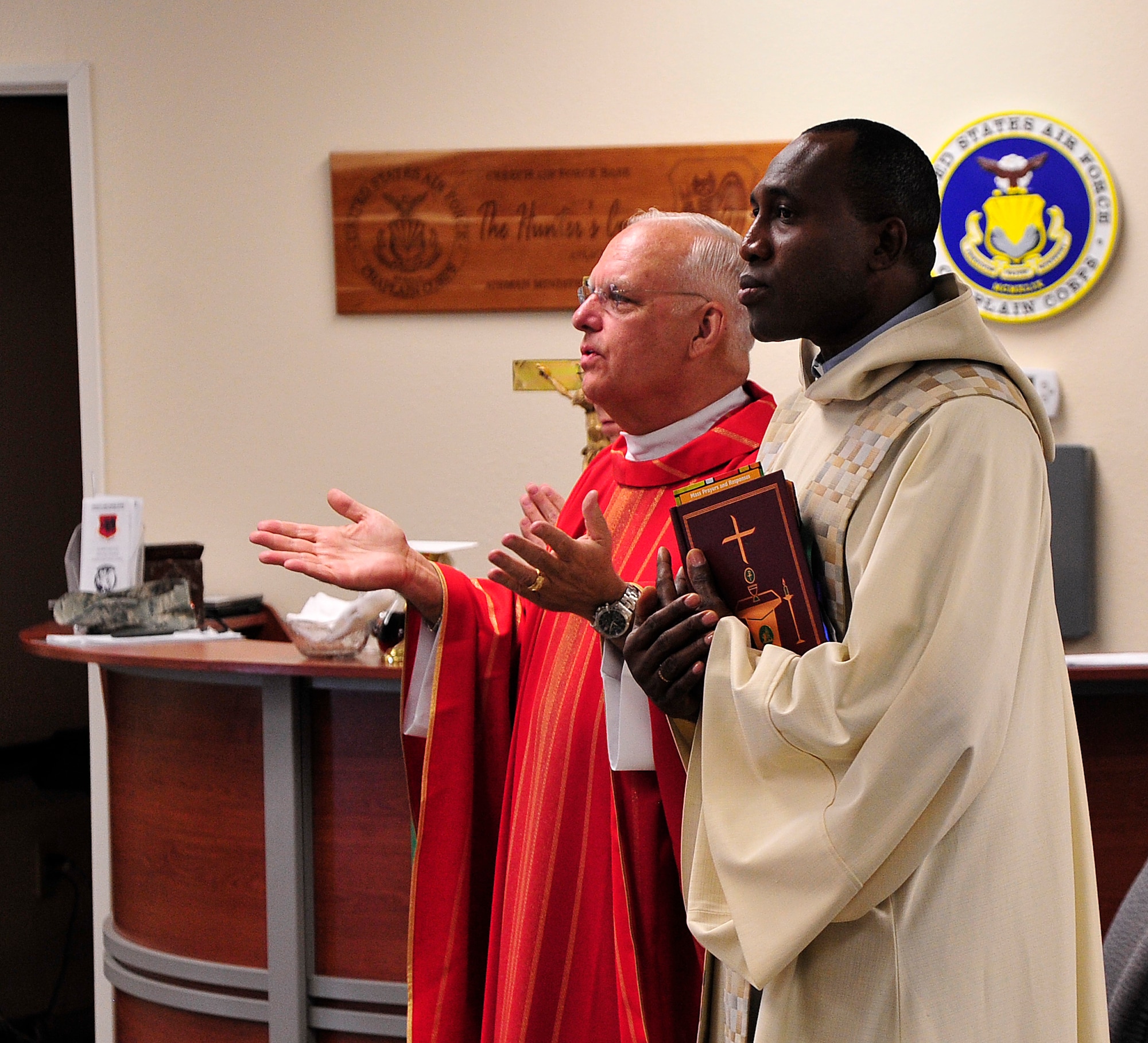 LAS VEGAS, Nev. -- Father John Kinney and Father Joseph Idomele celebrate Mass as part of the U.S. Air Force’s “Come Be With Us” chaplain recruiting tour June 11, 2013.  The tour brings active duty chaplains and civilian priests to Nellis and Creech Air Force Base to help recruit new chaplains. (U.S. Air Force photo by Staff Sgt. D.H./Released)