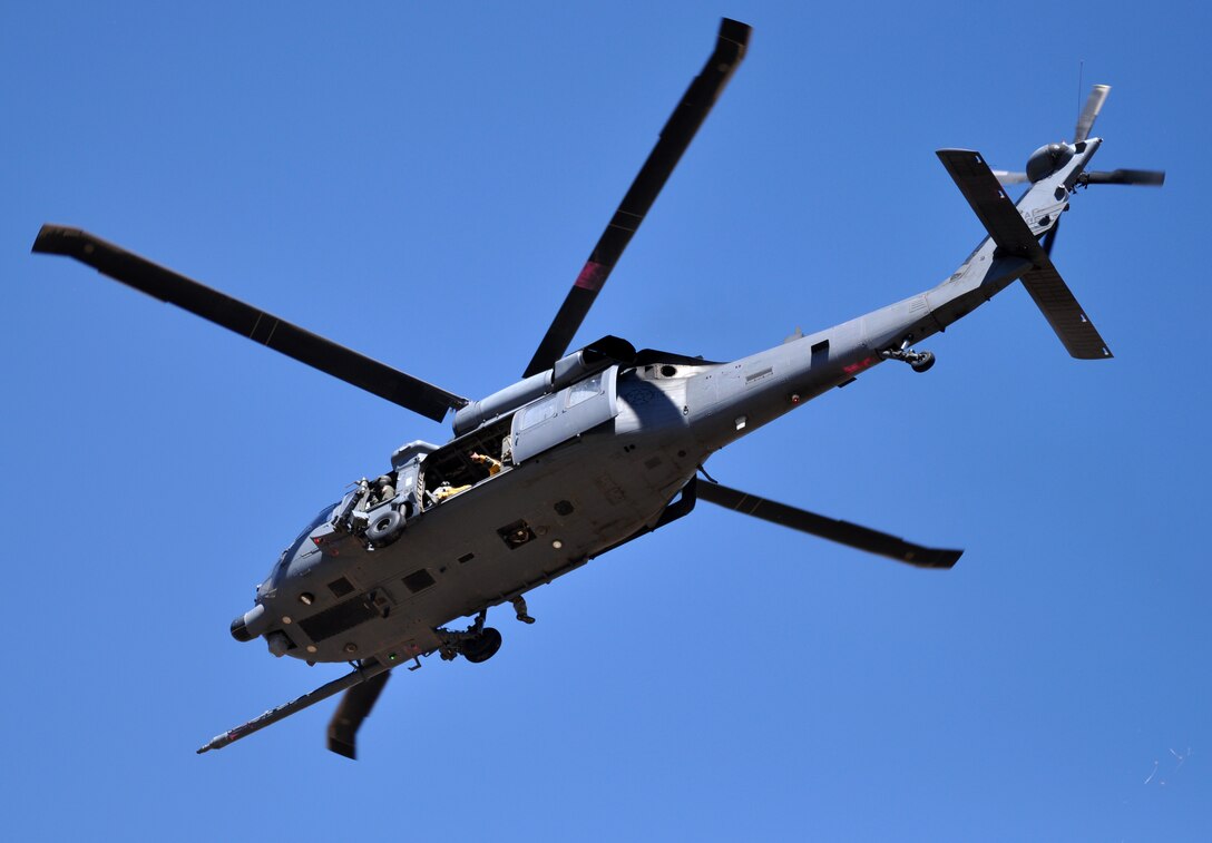 An HH-60G Pave Hawk flies away after a successful rescue of a downed U-2 pilot during a combat search and rescue exercise at Beale Air Force Base, Calif., May 31, 2013. The HH-60 Pave Hawk is assigned to the 129th Rescue Wing, Moffett Federal Airfield, Calif.  (U.S. Air Force photo by Robert Scott/Released)