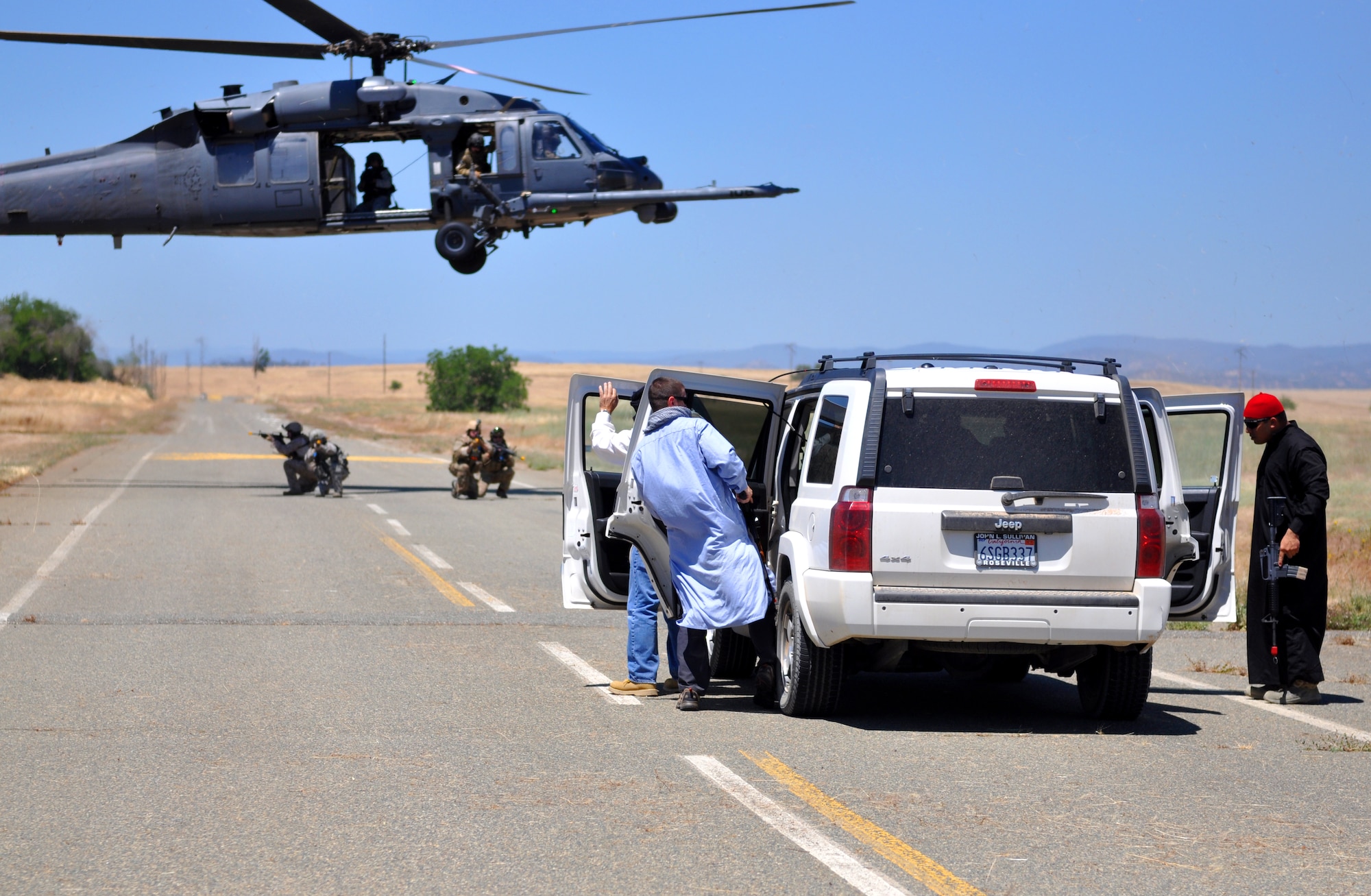 Members from the 129th Rescue Squadron and special operations forces perform vehicle interdiction during a combat search and rescue exercise at Beale Air Force Base, Calif., May 31, 2013. The squadron utilizes the HH-60G Pave Hawk for its CSAR missions. (U.S. Air Force photo by Robert Scott/Released)