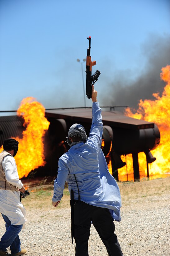 Simulated opposition forces celebrate the downing of U-2 Dragon Lady during a combat search and rescue exercise at Beale Air Force Base, Calif., May 31, 2013. Many base agencies participated in the exercise including the 129th Rescue Wing stationed at Moffett Federal Airfield, Calif. (U.S. Air Force photo by Robert Scott/Released)