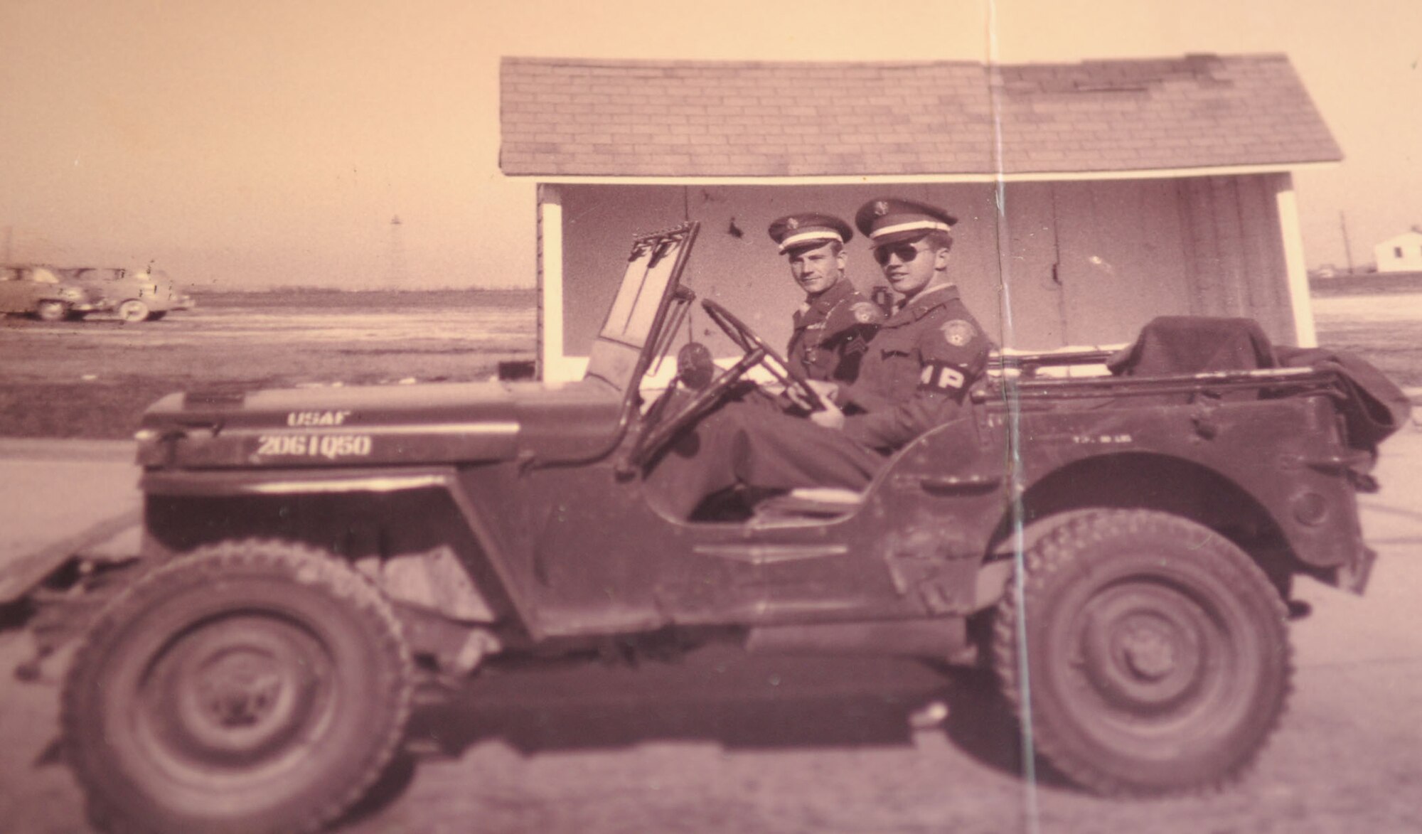 Dock Harris (right), a 32-year volunteer at the base pharmacy, is pictured in his Army Air Corps military police uniform in 1949. (courtesy photo)
